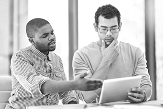 Two men looking at the ipad